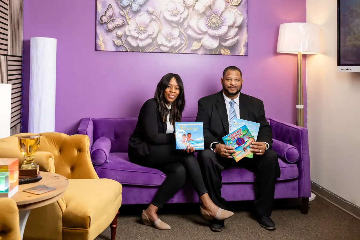 Louis and La'Toya Gatewood holding the DJ and Khai books
